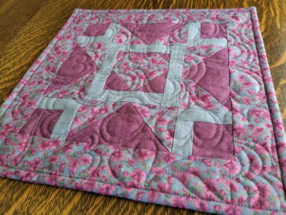 mini quilt in gray and purple with patchwork heart and star piecing