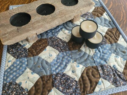 mini quilt with tea light candles and wooden holder