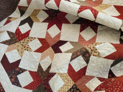 scrappy star throw quilt in brown, red and beige cotton fabrics