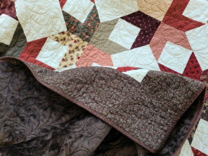 scrappy star throw quilt showing soft minky backing