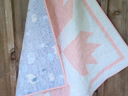 pink and white baby quilt showing soft minky backing