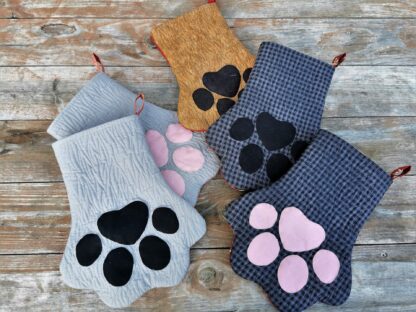 showing group of different colored pet paw stockings each sold separately